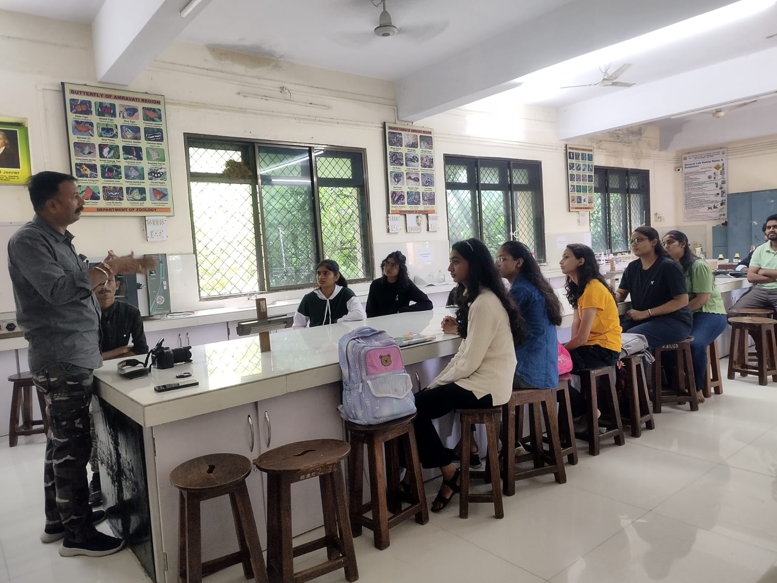 Teacher giving information to the student about project designing & writing.